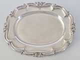 a silver plate with a decorative design on it