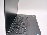a black laptop with a red button on the keyboard