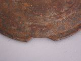 a rusted piece of metal on a white surface