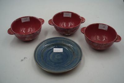 four red and blue bowls and a plate on a white table