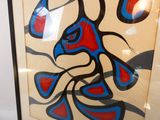 tableau représentant un oiseau au visage rouge et bleu, dans un cadre noir
