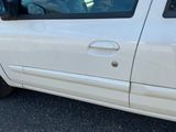 a white van parked in a parking lot with its door open