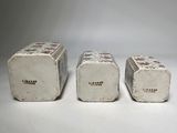 three pieces of cement sitting next to each other on a white surface