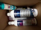 three bottles of lotion sitting in a cardboard box