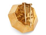 a close up of a gold plated object with chopsticks in it