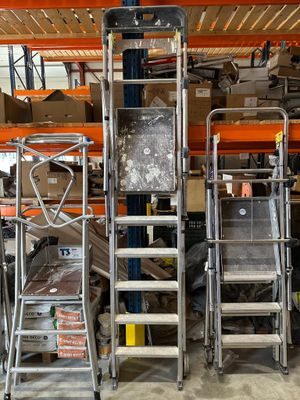 many different types of ladders in a warehouse