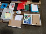 a pallet full of books and binders on the floor