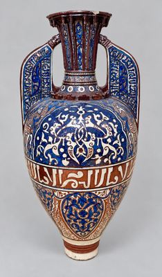 a blue and brown vase with a design on it