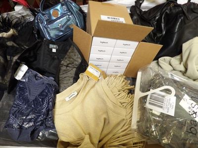 a box full of clothes and bags on the floor