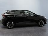 the black car is parked on the concrete floor in the room
