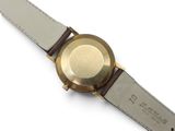 an image of a close up of a wrist watch on a white surface