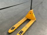the forklift is sitting on the concrete floor in the warehouse