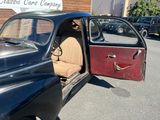 a car that is parked in front of a building with its door open