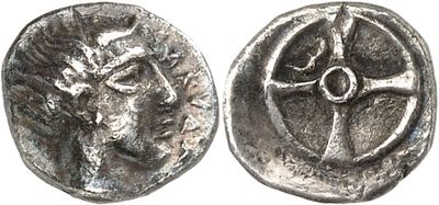 a close up of a coin with a cross on it