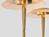 pair of brass table lamps on a white pedestal