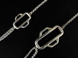 a close up of a pair of silver chains on a black surface