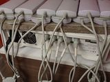 many wires that are connected to a computer on a desk
