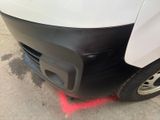 a close up of a white truck with red marks on it