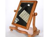 a wooden frame with a mirror on top of it