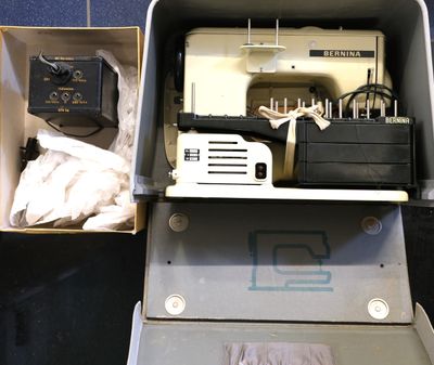 a box with a sewing machine and other items in it