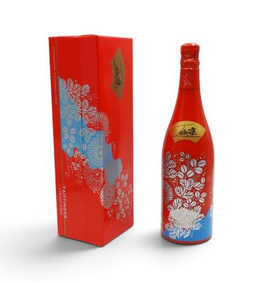 a bottle of red wine next to a red box