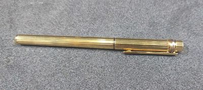 a close up of a pen laying on top of a table