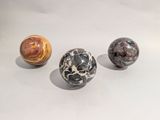 three marble balls sitting on top of a table next to each other
