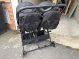 two strollers that are sitting next to each other on the street