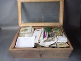 a small wooden box filled with lots of mail