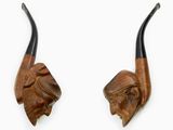 pair of carved horns with a man ' s head and a woman ' s head
