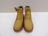 yellow boots with yellow laces on them sitting on a white surface