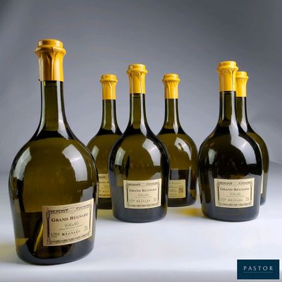 six bottles of wine are lined up in a row on a table