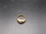 a close up of a gold ring on a metal surface