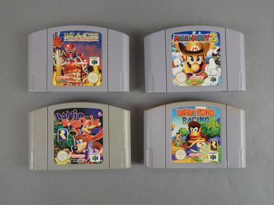 four nintendo game cartridges are lined up on a table