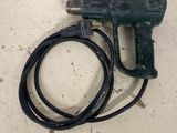 a close up of a cord connected to a drill on a table
