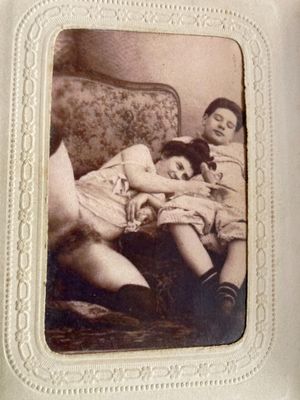 an old photo of two children sitting on a couch