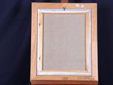 an old wooden easel with a painting on it on a blue background