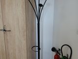 a coat rack and fire extinguisors in the corner of a room