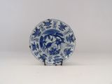 a blue and white plate with a bird on it