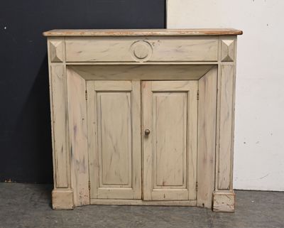 a small cabinet with a door on the top of it