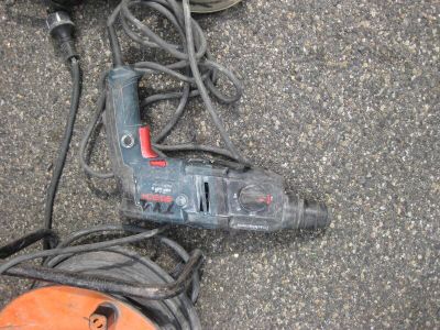 a corded cord and a corded drill on the ground