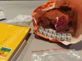 a paper bag full of stamps and a book on a table