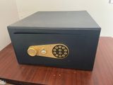 an open safe box sitting on top of a wooden table