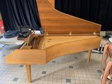 a piano that is sitting on the floor in the room