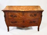 an old wooden chest of drawers with marble top