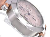 a person holding a wrist watch with a pink dial