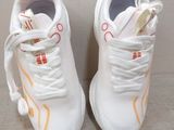 pair of white sneakers with red and orange details on them