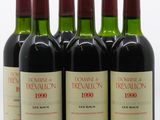 six bouteilles de vin rouge sont alignées sur une surface blanche