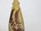 a yellow vase with a brown design on it