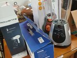 a blender sitting on top of a wooden table next to a box